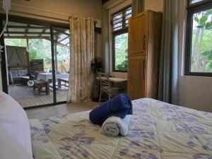 Ένα ή περισσότερα κρεβάτια σε δωμάτιο στο La Petite Ferme, Le Pavillon