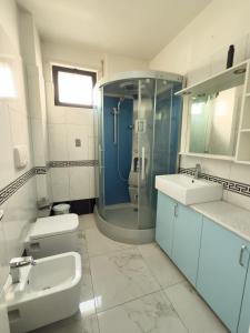 a bathroom with a shower and a toilet and a sink at Sea View Apartaments in Durrës