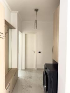 a kitchen with a washing machine in a room at Sea View Apartaments in Durrës