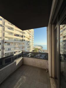 a balcony with a view of a building at Sea View Apartaments in Durrës +63 photos