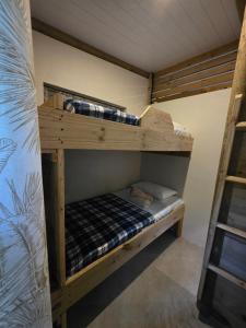 a couple of bunk beds in a room at Le Pavillon, at La Petite Ferme 2BRoom with private fireplace in Grand Sable