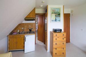 a kitchen with a sink and a white refrigerator at Ferienhaus Bleicken in Morsum