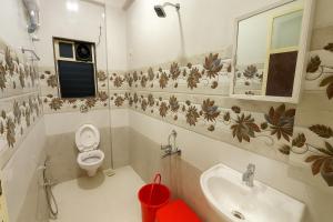 a bathroom with a toilet and a sink at Beach Aura By Lavika Stays in Nagaon