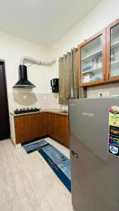 a kitchen with a refrigerator in the middle of a room at VINTAGE VISTA RESORTs in Chennai