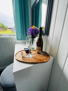 a bottle of wine and a glass on a table at Tigh Na Sealladh in Dunoon