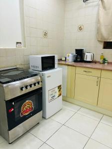 a kitchen with a microwave on top of a stove at Vibrant Studio Near the Beach in Jan Thiel +6 photos