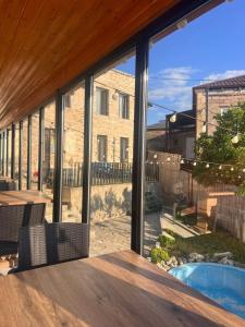a view of a patio with a large glass window at Comfortable House the city centr in Kutaisi
