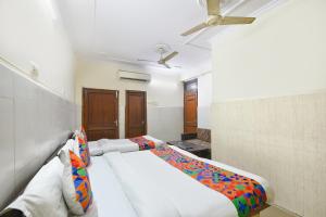 a bed in a room with a ceiling fan at FabHotel Shiv Palace in New Delhi +18 photos