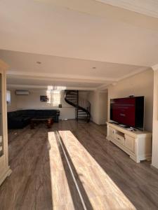 a large living room with a large flat screen tv at Comfortable House the city centr in Kutaisi
