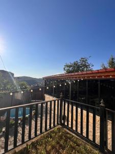 a building with a fence next to a pool at Comfortable House the city centr in Kutaisi
