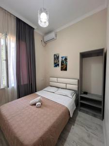 a bedroom with a large bed with a pink blanket at Comfortable House the city centr in Kutaisi +22 photos