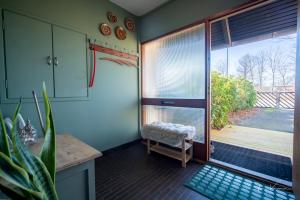 a kitchen with a sliding glass door to a balcony at FeWo Lille Lægehus in Hjørring
