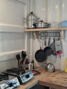a kitchen with a counter top with pots and pans at Le Pavillon, at La Petite Ferme 2BRoom with private fireplace in Grand Sable