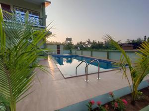 a swimming pool on the roof of a house at Beach Aura By Lavika Stays in Nagaon +8 photos