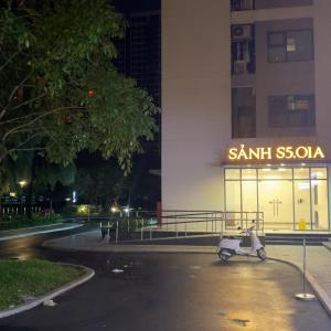 a scooter parked in front of a building at night at Milo's Home in Gò Công