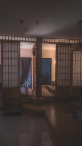 a room with a bed in a room with windows at Milo's Home in Gò Công