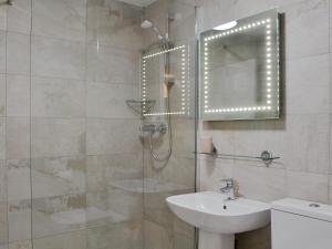 a bathroom with a sink and a glass shower at 11 Elm Court in Keswick