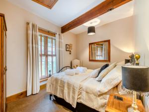 a bedroom with a bed and a window at Bockety Barn in Stalham +11 photos
