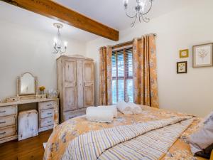 a bedroom with a bed and a dresser and a window at Bockety Barn in Stalham