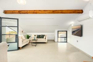 a living room with a couch and a table at Sunny Hilltop Hideaway by Sea N' Rent in Tefahot