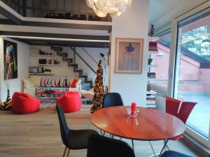 ピゾーニェにあるAros Mountain Lake Iseo Hospitaliyのテーブルと椅子、クリスマスツリーが備わる部屋