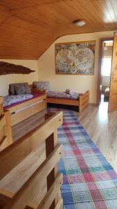 a room with two beds and a rug at Chalupa Aja in Čierny Blh