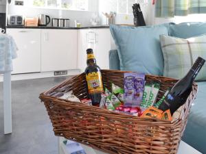 a basket with a bottle of beer and snacks at Field House Lodge in Borrowdale Valley