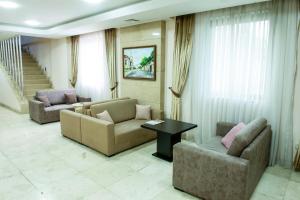 a living room with two couches and a table at Atropat Old City Hotel in Baku +62 photos
