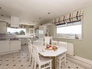a kitchen with a white table and white chairs at North Dean in Winster +27 photos