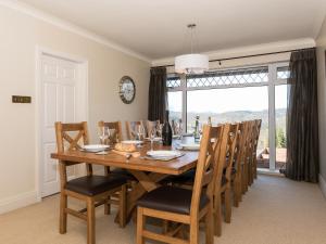 a dining room with a wooden table and chairs at North Dean in Winster