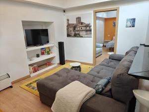 a living room with a couch and a flat screen tv at Casa Diego in Melias