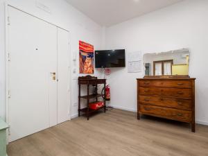 a room with a dresser and a television in it at Nenne' Home in Sorrento