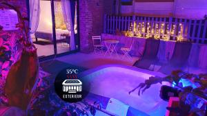 a swimming pool in a room with purple lighting at GARY Suite - Studio Cosy, Spa et jardin privatif à 4 min de Cambrai in Awoingt +32 photos