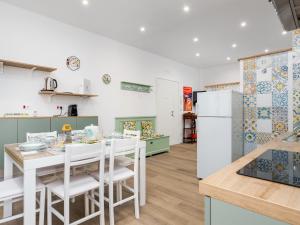 a kitchen and dining room with a table and chairs at Nenne' Home in Sorrento +32 photos