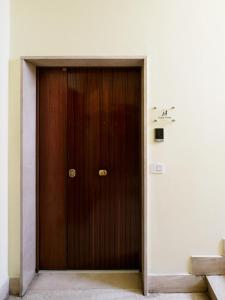 a brown wooden door in a room with a wall at Nenne' Home in Sorrento