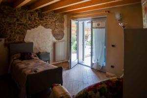 a bedroom with a bed and a sliding glass door at Il Bosco dei 100 Acri in Roncobello