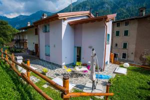 a small house in a yard next to a building at Il Bosco dei 100 Acri in Roncobello +7 photos