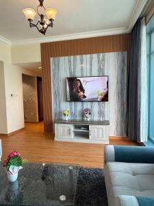 a living room with a tv on a wall at Full seaview luxury with gym,pool,jacuzzi,sauna,24x7 cafe,beach,restaurants,medical and more in Ajman  +31 photos