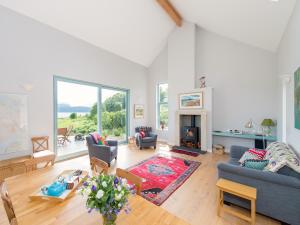 a living room with a couch and a fireplace at Tigh An Iasgair in Fearnmore