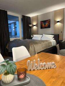 a hotel room with a bed and a wooden table at Premium Apartment Wohlfühl-Oase mit Pool und Sauna in Sankt Englmar