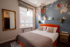 a bedroom with a large bed and a mirror at Piotrkowska 89 Residence in Łódź +88 photos