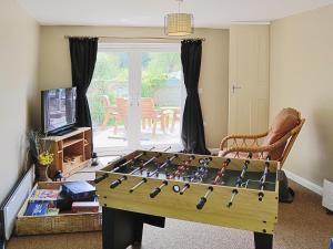 a living room with a foosball table at Mill Haven in Dunster +7 photos