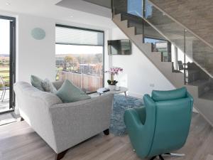 a living room with a couch and a stairway at The Retreat - Ukc3845 in Ticknall