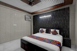 a bedroom with a large bed in a room at FabHotel Vrishti Residency in Greater Noida
