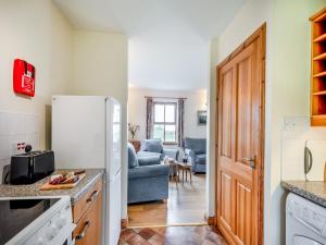 a kitchen with a refrigerator and a living room at Cruinn in Taynish +10 photos