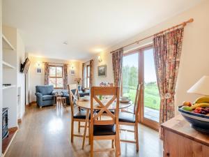a kitchen and living room with a table and chairs at Cruinn in Taynish