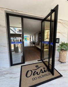 an open door sign in front of a building at Apartamento Novinho na Praia de Palmas em Gov Celso Ramos in Governador Celso Ramos +24 photos