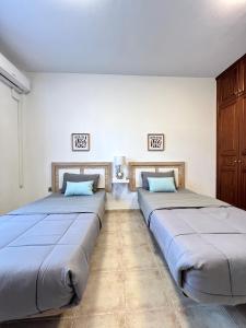 two beds sitting next to each other in a room at Villa Petra in Tuineje +47 photos