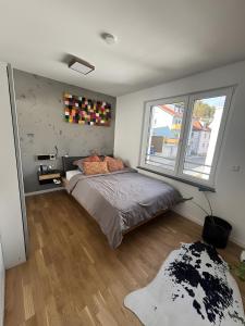 a bedroom with a bed and a large window at Willkommen in Ihrem Luxus-Penthouse in Ziegelhausen