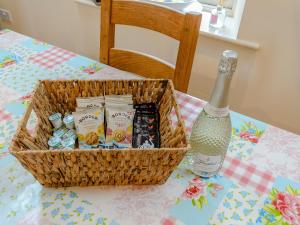 a basket of candy and a bottle of champagne on a table at Westwood Barn in Brough Sowerby
